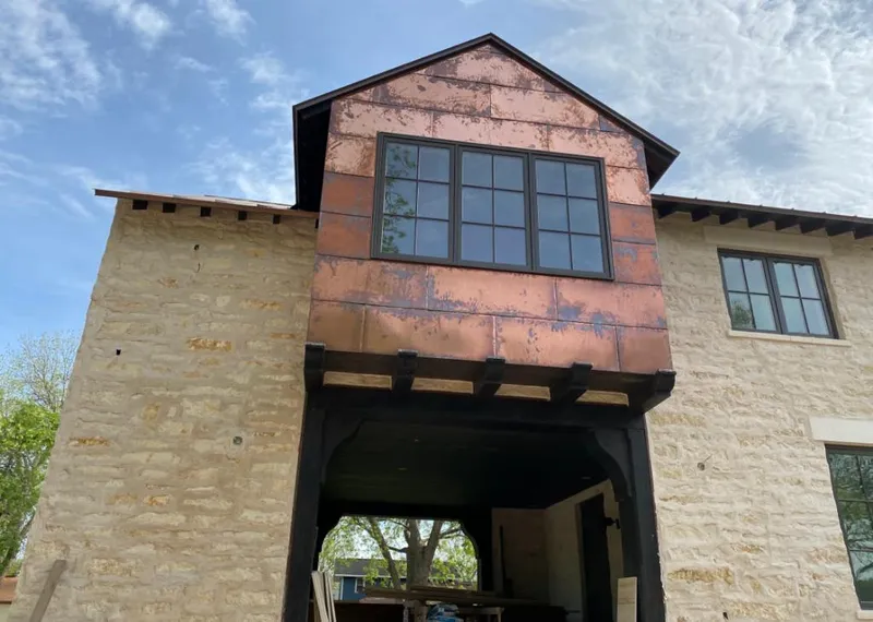 Copper metal panel facade on a stone building for Skylight Installation in Haiku-Pauwela